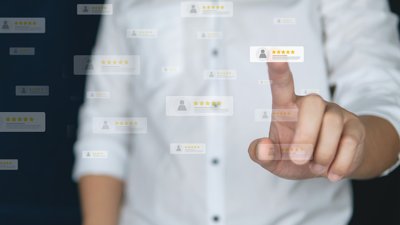man in white shirt looking at business reviews