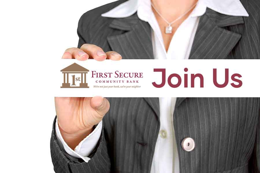Manager at 1st secure bank holding a join us signs